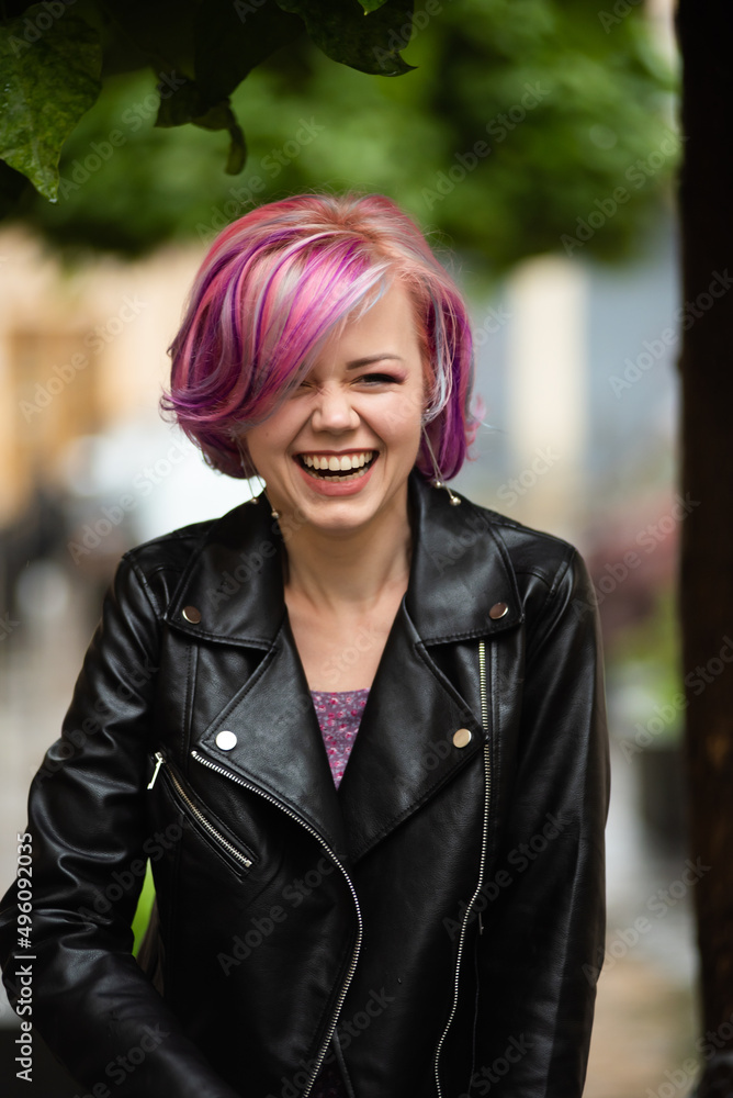 Smiling woman with pink hair outdoor