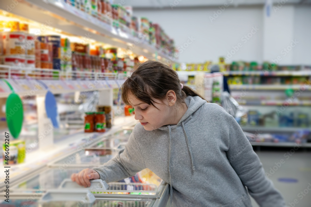 Portrait of smiling cute teen girl  in supermarket