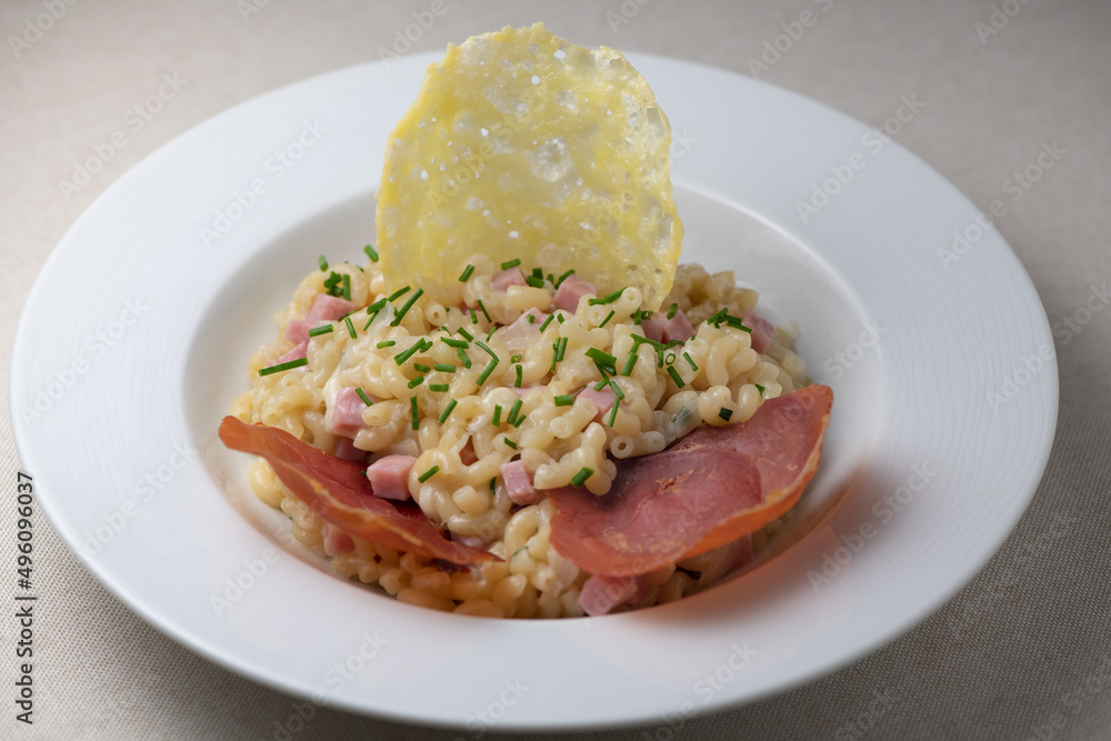 Pastasotto recipe with shells and ham, ham and cheese tiles, High quality photo Pastasotto recipe with shells and ham, ham and cheese tiles, High quality photo