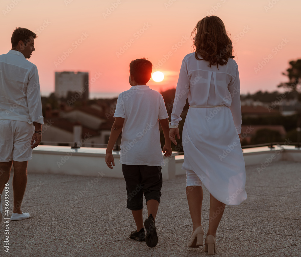 Fototapeta premium Happy family enjoys and spends time together on the roof of the house. Selective focus