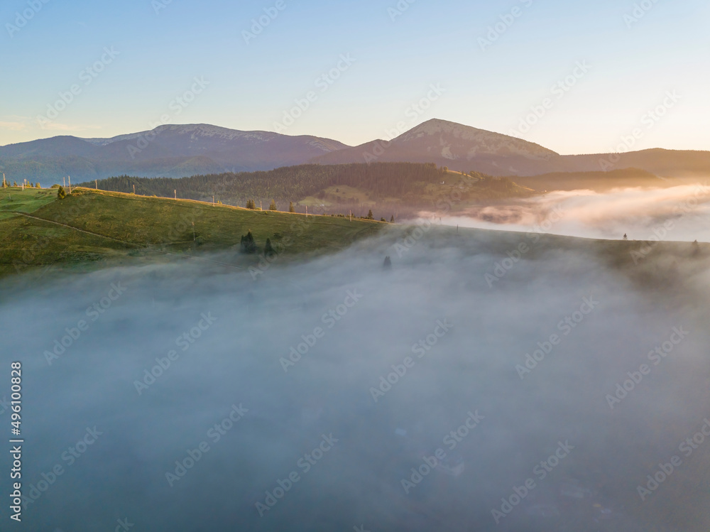 Sunrise over the fog in the Ukrainian Carpathians. Aerial drone view.
