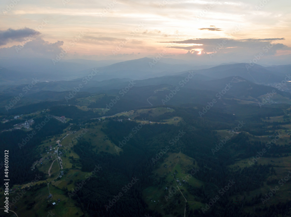 Sunset over the mountains in the Ukrainian Carpathians. Evening. Aerial drone view. Sunset over the mountains in the Ukrainian Carpathians. Evening. Aerial drone view.