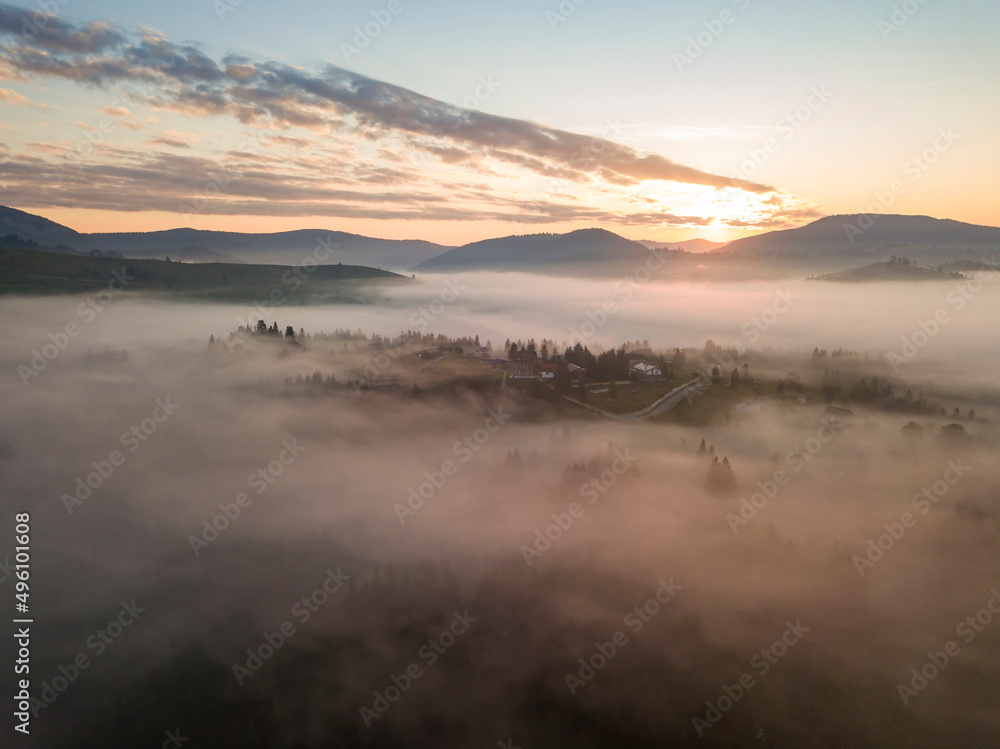 Fototapeta premium Sunrise over the fog in the Ukrainian Carpathians. Aerial drone view.