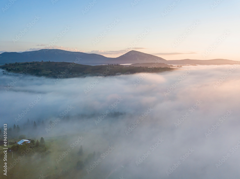 Sunrise over the fog in the Ukrainian Carpathians. Aerial drone view.