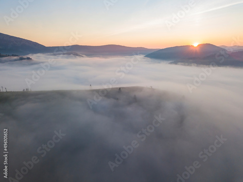 Sunrise over the fog in the Ukrainian Carpathians. Aerial drone view.