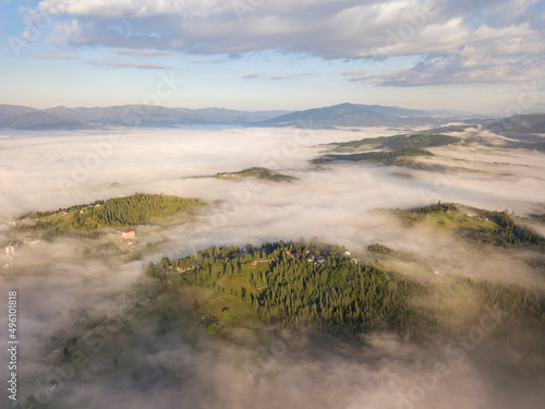 Fototapeta Naklejka Na Ścianę i Meble -  Green mountains of the Ukrainian Carpathians in the morning fog. Aerial drone view.
