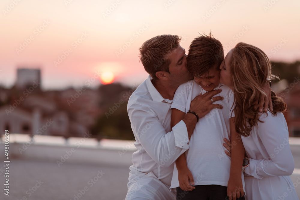 Happy family enjoys and spends time together on the roof of the house. Selective focus Happy family enjoys and spends time together on the roof of the house. Selective focus
