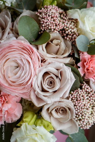 Bright pink flowers bouquet closeup. Roses and orchids wallpaper. Beautiful background for a Birthday, International Female Day, or Saint Valentine. The festive backdrop for a postcard design