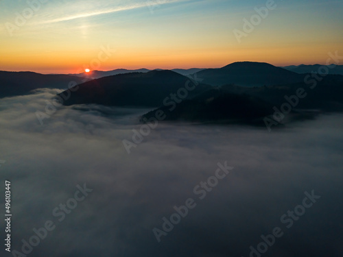 Sunrise over the fog in the Ukrainian Carpathians. Aerial drone view.