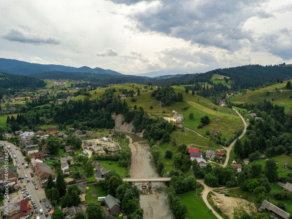 Settlement in the mountains of the Ukrainian Carpathians. Aerial drone view.