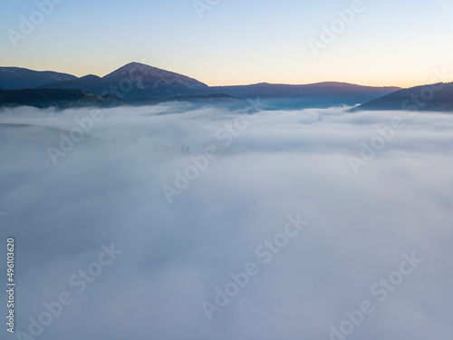 Sunrise over the fog in the Ukrainian Carpathians. Aerial drone view.