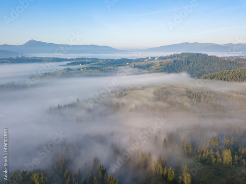 Morning mist in Ukrainian Carpathian mountains. Aerial drone view.
