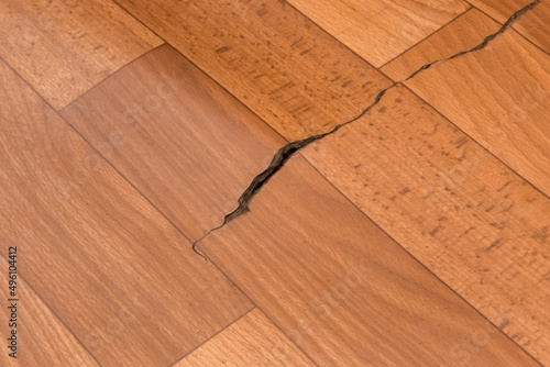 Broken torn linoleum old rubber PVC floor damage material, flooring repair photo