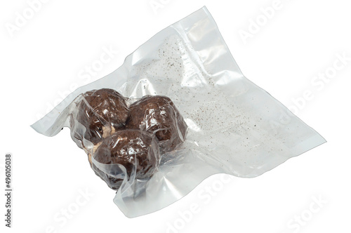 isolated on a white background are three balls of Belper Knoll cheese in a vacuum package. Hard Swiss cheese in the form of small balls, sprinkled with black pepper. side view. photo