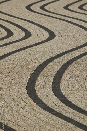 Decorative sidewalk with curved lines.