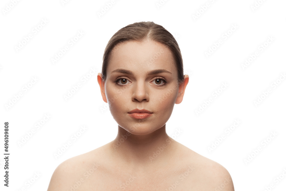 One young beautiful woman with perfect no makeup face, looking at camera isolated over white studio background. One young beautiful woman with perfect no makeup face, looking at camera isolated over white studio background.