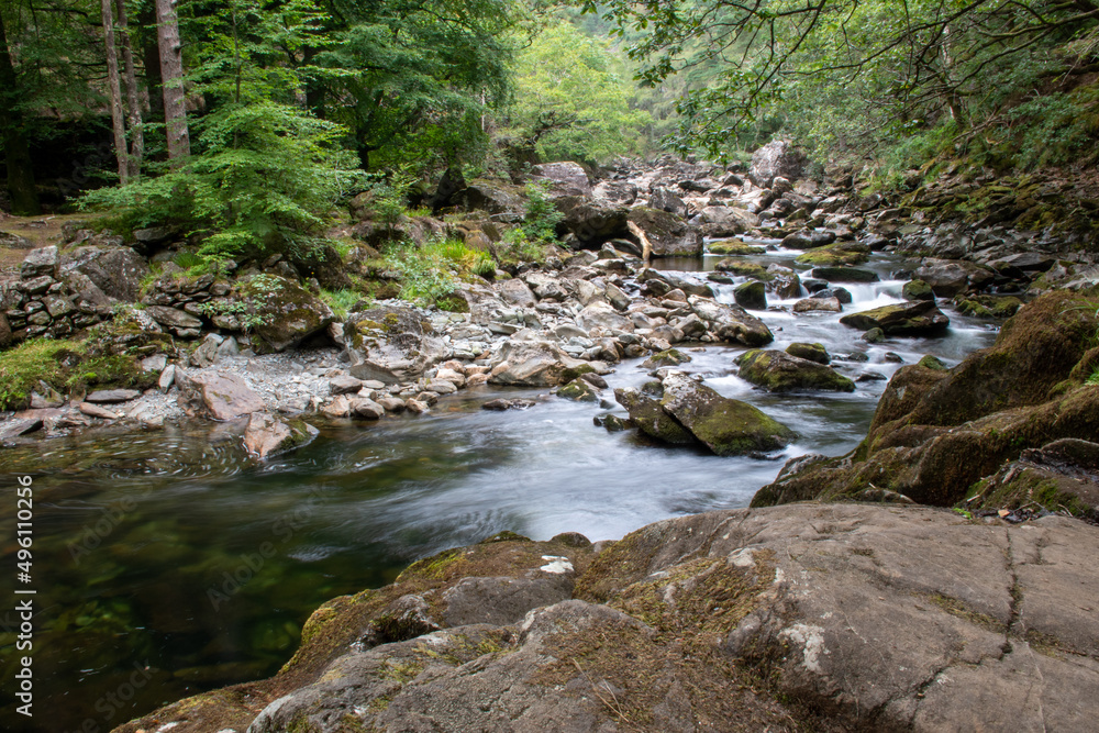 Fast flowing water/waterfalls flowing through the Aberglaslyn Pass near to Beddgelert, in Snowdonia National Park, north Wales Fast flowing water/waterfalls flowing through the Aberglaslyn Pass near to Beddgelert, in Snowdonia National Park, north Wales