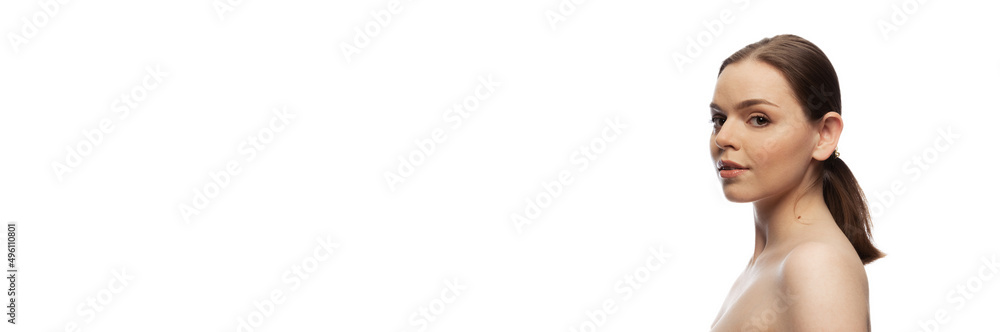 Portrait of young tender woman with natural nude makeup and low ponytail posing, looking at camera isolated over white studio background. Flyer Portrait of young tender woman with natural nude makeup and low ponytail posing, looking at camera isolated over white studio background. Flyer