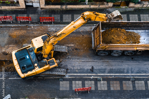 construction equipment excavates a city street to improve the wastewater infrastructure. Top View. Selective Focus Machine