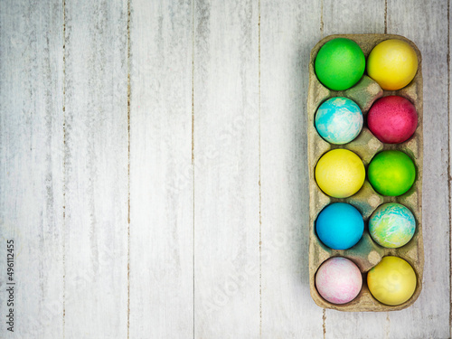 Multicolored painted eggs on a gray background. Easter concept