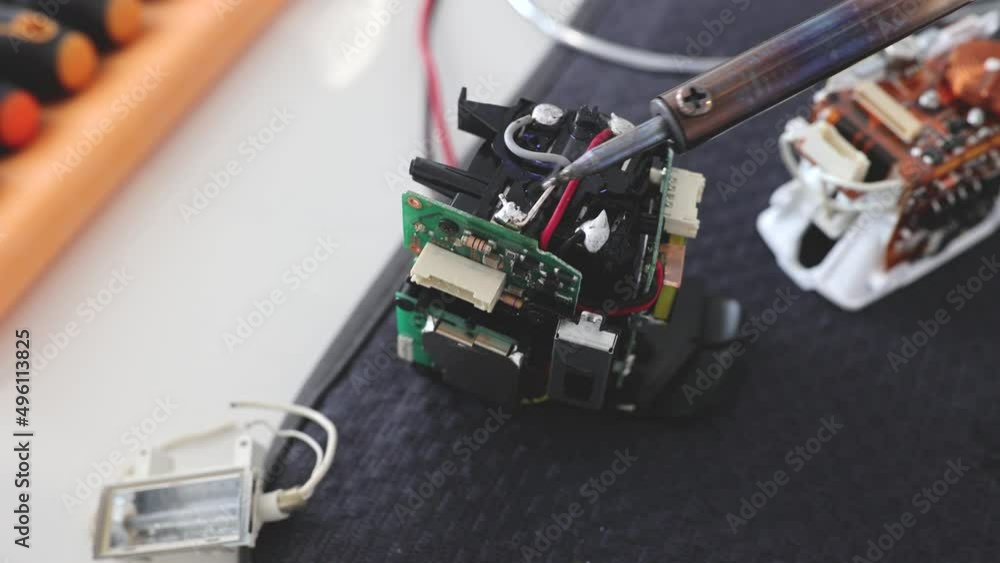 Man hold tool repairs electronics manufacturing Services, Manual Assembly Of Circuit Board Soldering. Man hold tool repairs electronics manufacturing Services, Manual Assembly Of Circuit Board Soldering.