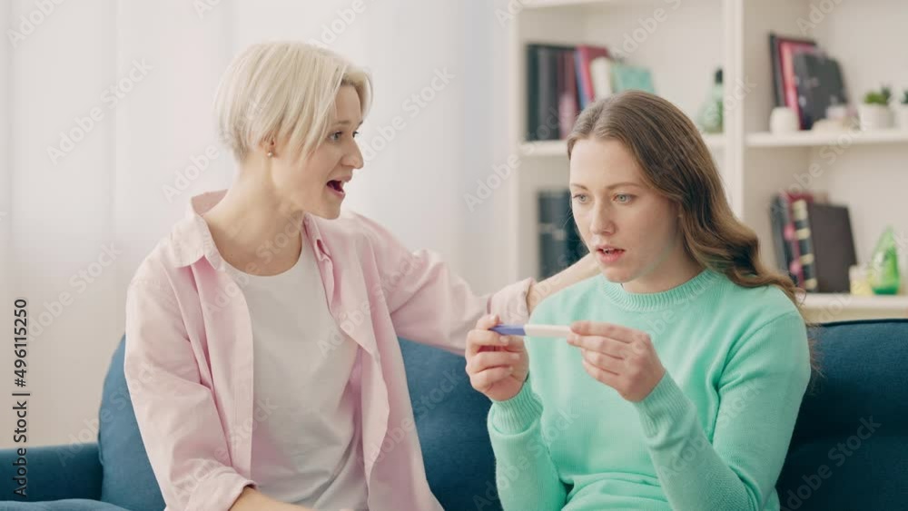 Excited lesbian couple learning news about pregnancy, donor conception