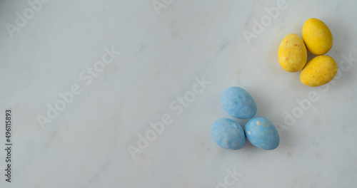 easter eggs in patriotic colors on a marble table. flat lay. place for text. minimalistic happy easter concept. view from above