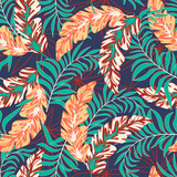 Summer seamless tropical pattern with bright plants and leaves on a purple background. Colorful stylish floral. Trendy summer Hawaii print. Seamless pattern with colorful leaves and plants.