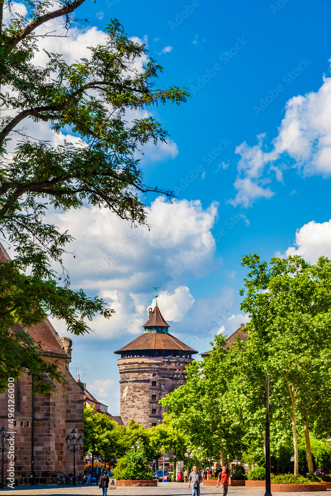 Lovely view of the famous Spittlertorturm from afar at the end of the street Ludwigstraße, seen from the square Jakobsplatz. The medieval fortress tower gate is in the southwest of Nürnberg, Germany.