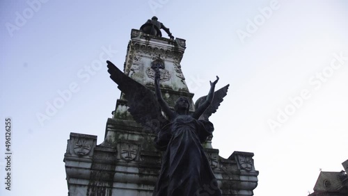 angel sculpture against blue clear sky and epic magic sunshine, apocalypse end of there world concept  photo