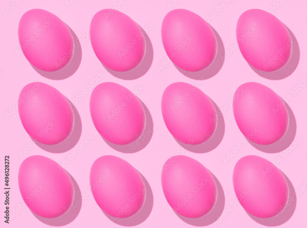 Easter Egg pattern: pink raw chicken eggs on pink background. Top view, healthy food.