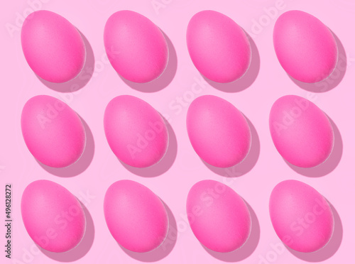 Easter Egg pattern: pink raw chicken eggs on pink background. Top view, healthy food.