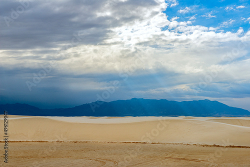 Sand dunes  clouds and mountains at White Sands National Park in New Mexico  USA
