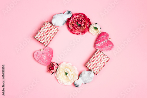 Romantic round frame of gifts  flowers  birds and decorative hearts on pink background. Place for text  top down composition.