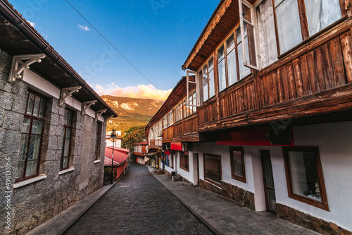 beautiful street with stone historical houses and paving stones against the backdrop of mountains in the resort of Gurzuf in the Crimea