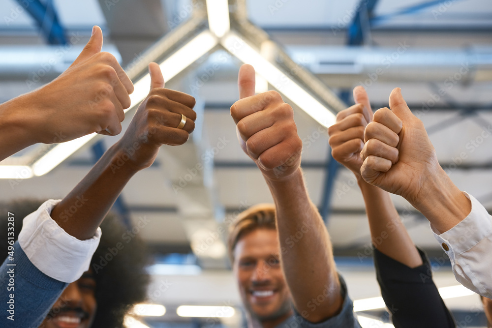 Youve got our approval. Cropped shot of a group of designers giving you the thumbs up in their office. Youve got our approval. Cropped shot of a group of designers giving you the thumbs up in their office.
