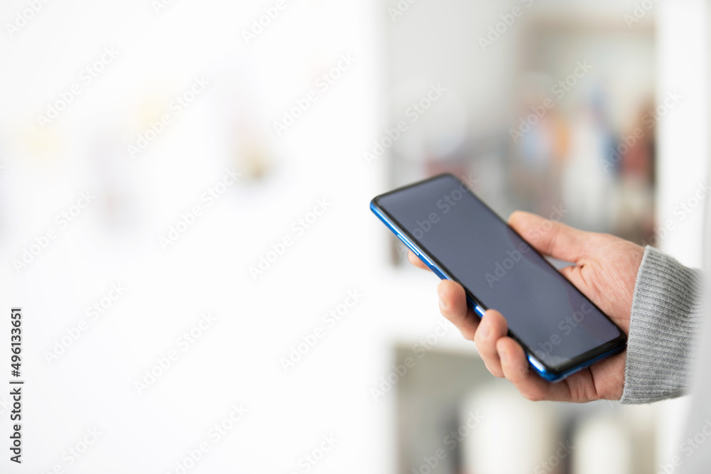 Male hands typing on smartphone