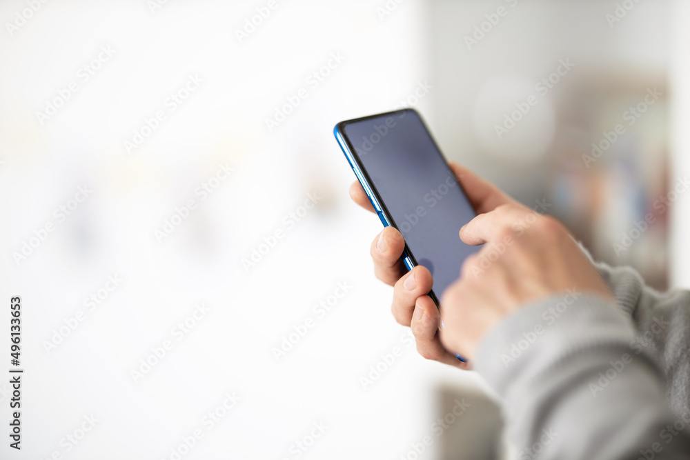 Male hands typing on smartphone