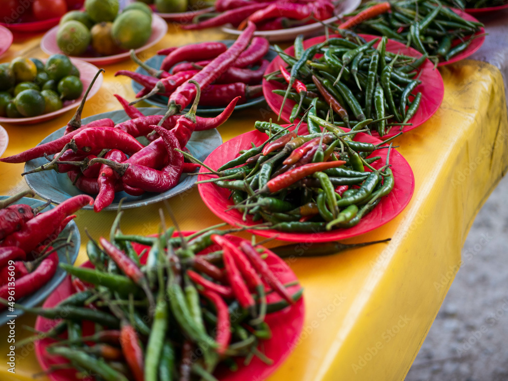 Red chili peppers and bird's eye chili in the plate at the wet market in Malaysia Red chili peppers and bird's eye chili in the plate at the wet market in Malaysia