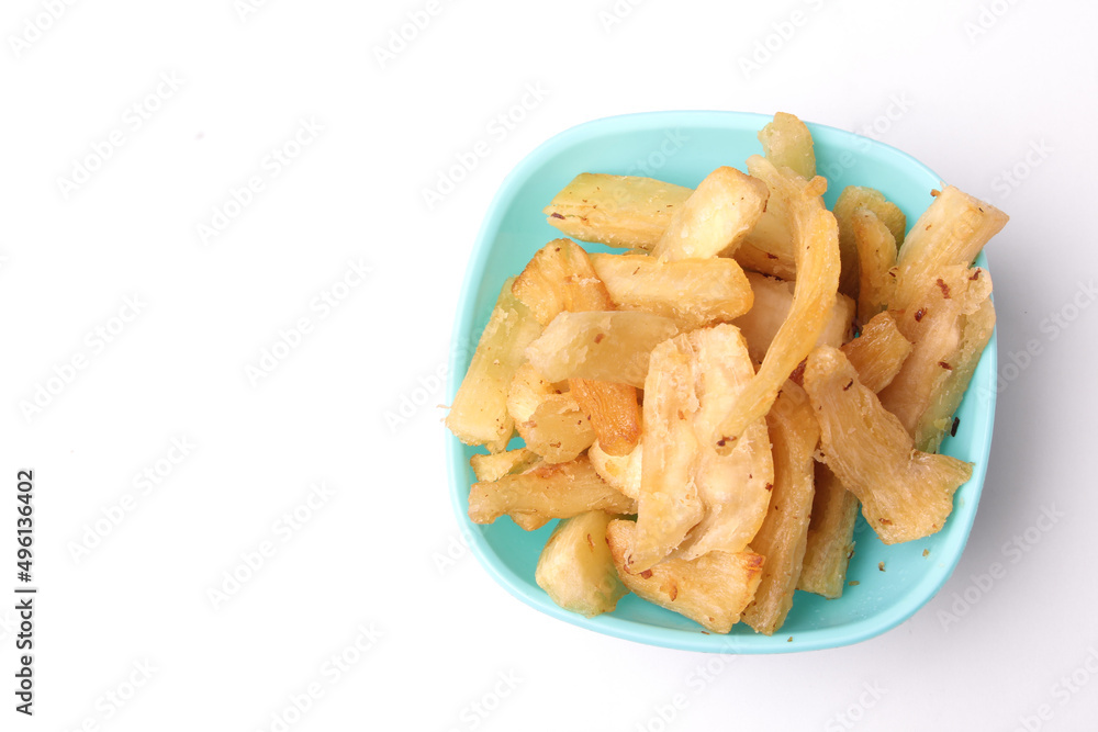 selective focus of fried cassava in blue bowl on white background, copy space, texture, Indonesian food. selective focus of fried cassava in blue bowl on white background, copy space, texture, Indonesian food.
