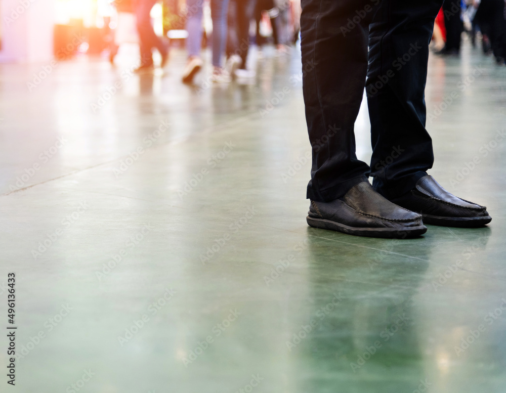 Man legs standing in exhibition hall Man legs standing in exhibition hall