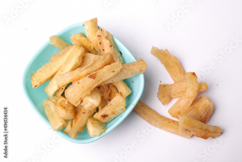 photo shoot from above Fried cassava in blue bowl on white background, copy space, texture, Indonesian food.