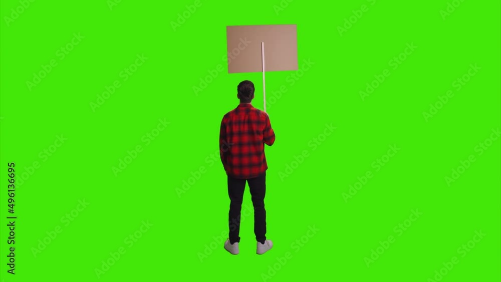 A teenage boy is standing with a banner in his hands facing the opposite direction on greenscreen A teenage boy is standing with a banner in his hands facing the opposite direction on greenscreen