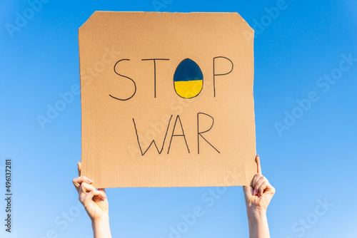 Stop war in Ukraine. Stop the war poster on a background of blue sky. The war in Ukraine.  Stand with Ukraine