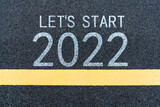 Number 2022 and yellow line on asphalt road