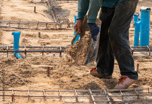 Workers fill san to ground for adjust level.