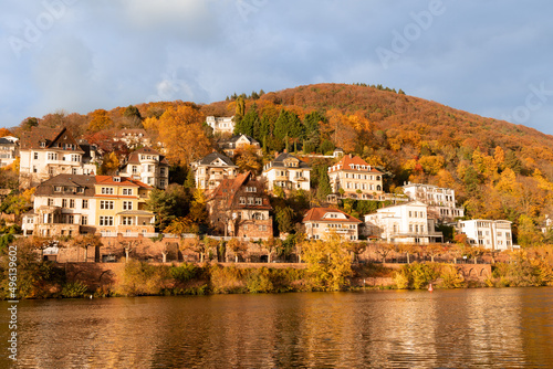 Philosophenweg at sunset in Heidelberg, Germany. Old luxurious buildings in orange fall colours. Beautiful background. Gorgeous colourful leaves on a hill. Red roofs. Heidelberg, Germany