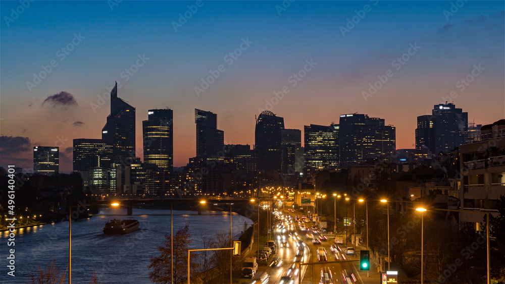 Dusk Over Skyline of La Defense With Boat on Seine River and Road Traffic