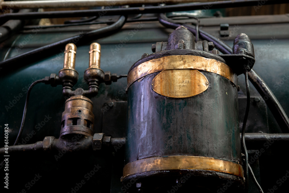Closeup A long-used metal device filled with oil stains is mounted on a steam locomotive Closeup A long-used metal device filled with oil stains is mounted on a steam locomotive