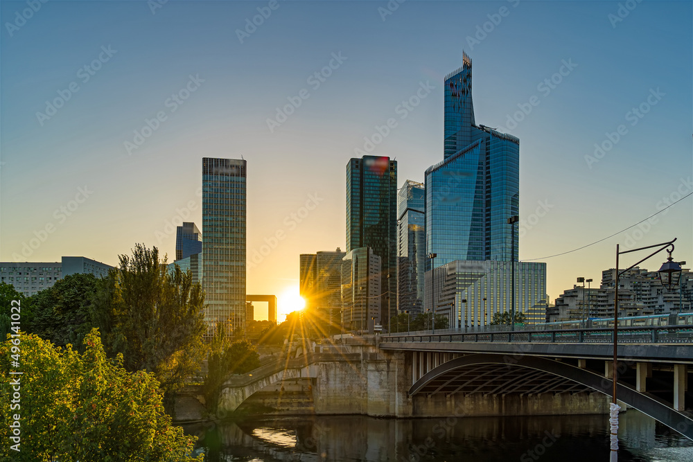 Fototapeta premium La Defense District in Paris at Sunset With Traffic and Seine